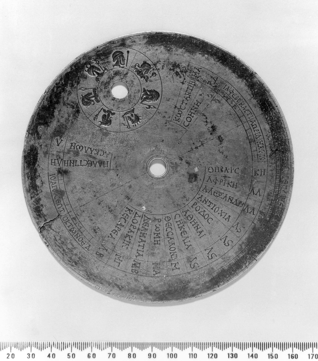 Figure 3 — The sundial plate of the Byzantine sundial-calendar, photographed with a scale in centimetres. Around the rim are engraved the Greek names of the places for which it could tell the time.