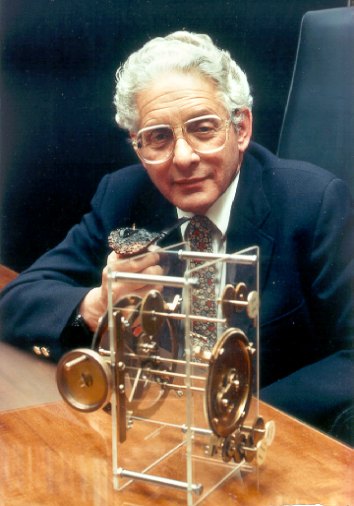 Figure 4 — Derek J. de Solla Price (1922–1983) with one of his models of the mechanism's gearing. Price worked on the fragments for about twenty years, published "An Ancient Greek Computer" in Scientific Amer…