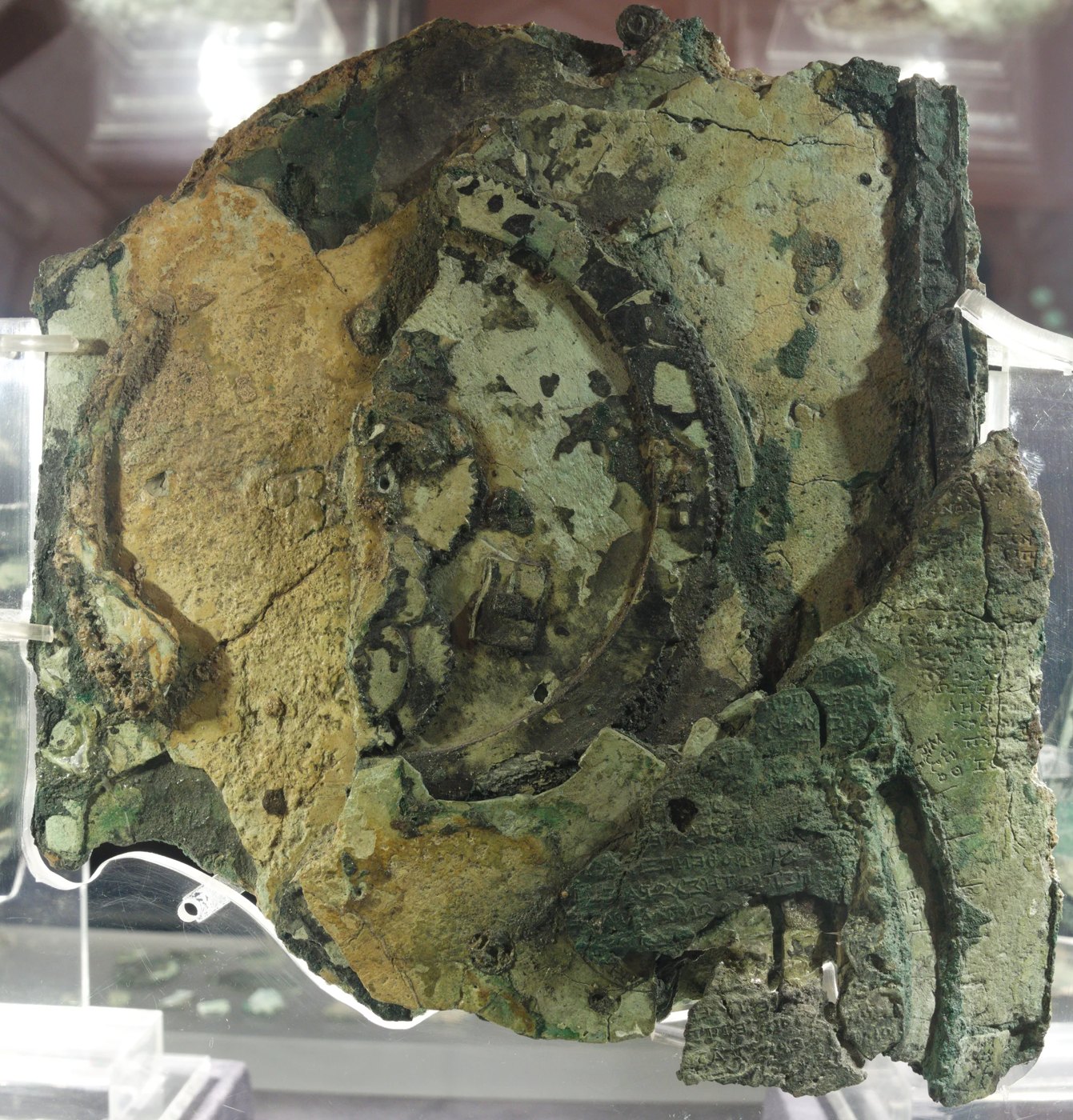 Figure 6 — Fragment A from the back. Part of the lower back dial survives on this face, though most of its scale divisions and glyphs, and the Exeligmos dial, are legible only in X-ray CT; the surface is over…