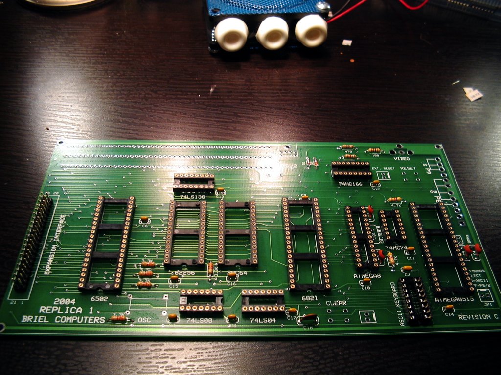 Figure 4 — Stage 1 complete on a Replica 1 board: resistors fitted and every socket soldered flat, notches matching the outlines, before any active part goes on.