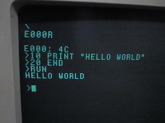 Figure 1 — Apple BASIC on a Briel Replica 1: RESET gives the backslash; E000R enters BASIC (the monitor first opens $E000, showing its byte 4C, after a blank line); a two-line program is typed at the > prompt…