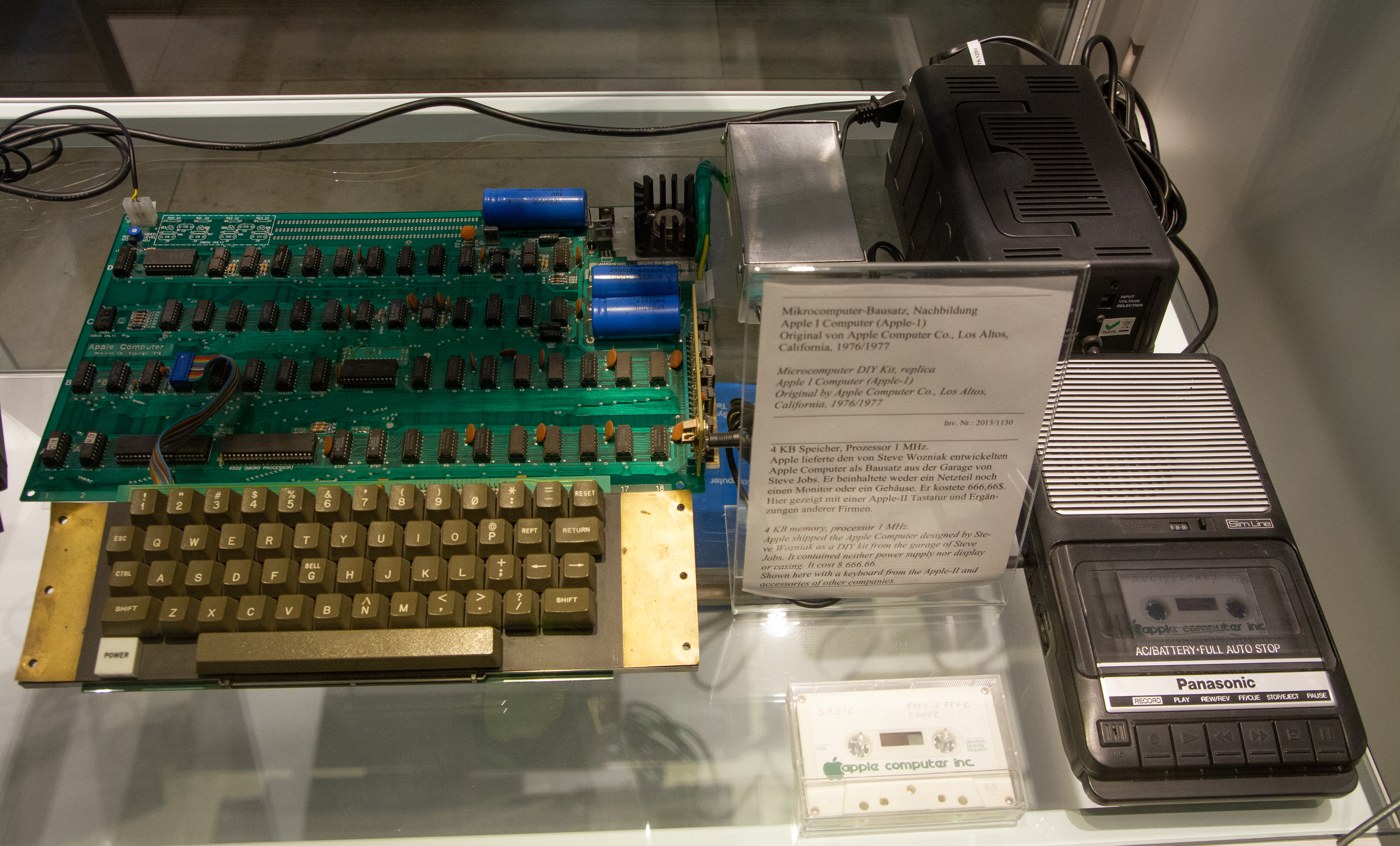 Figure 3 — An Apple-1 set up as a working home computer, on display in 2019: the board, a period keyboard, a cassette tape and a portable cassette recorder for loading BASIC and saving programs.