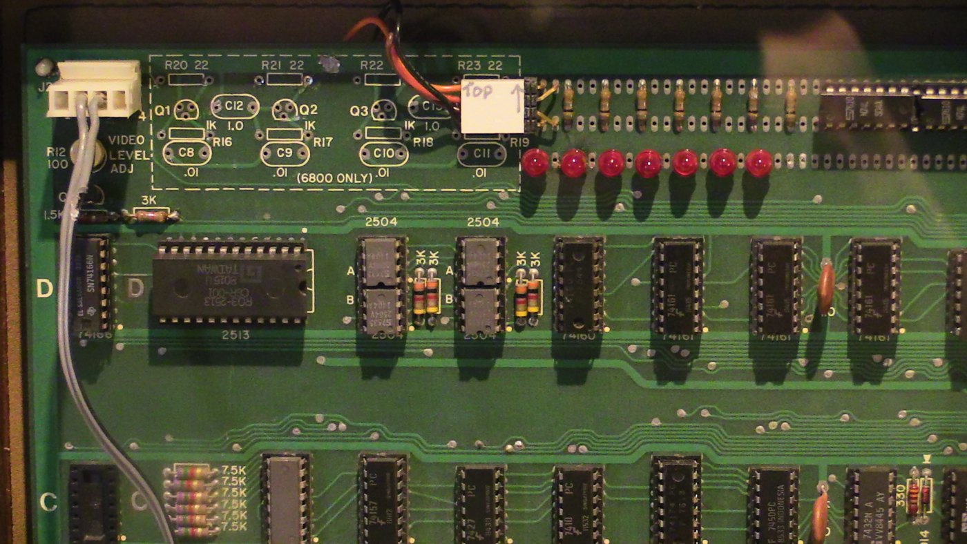 Figure 6 — The video section of an original board: the Signetics 2513 character generator (left of centre) and the 2504 dynamic shift registers that hold the screen, with the video Molex connector and level p…