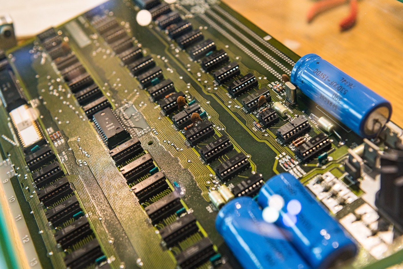 Figure 2 — Detail of the Apple-1 in the permanent exhibition of the Heinz Nixdorf MuseumsForum in Paderborn, Germany, among the world's largest computer museums. The three large blue electrolytic capacitors a…