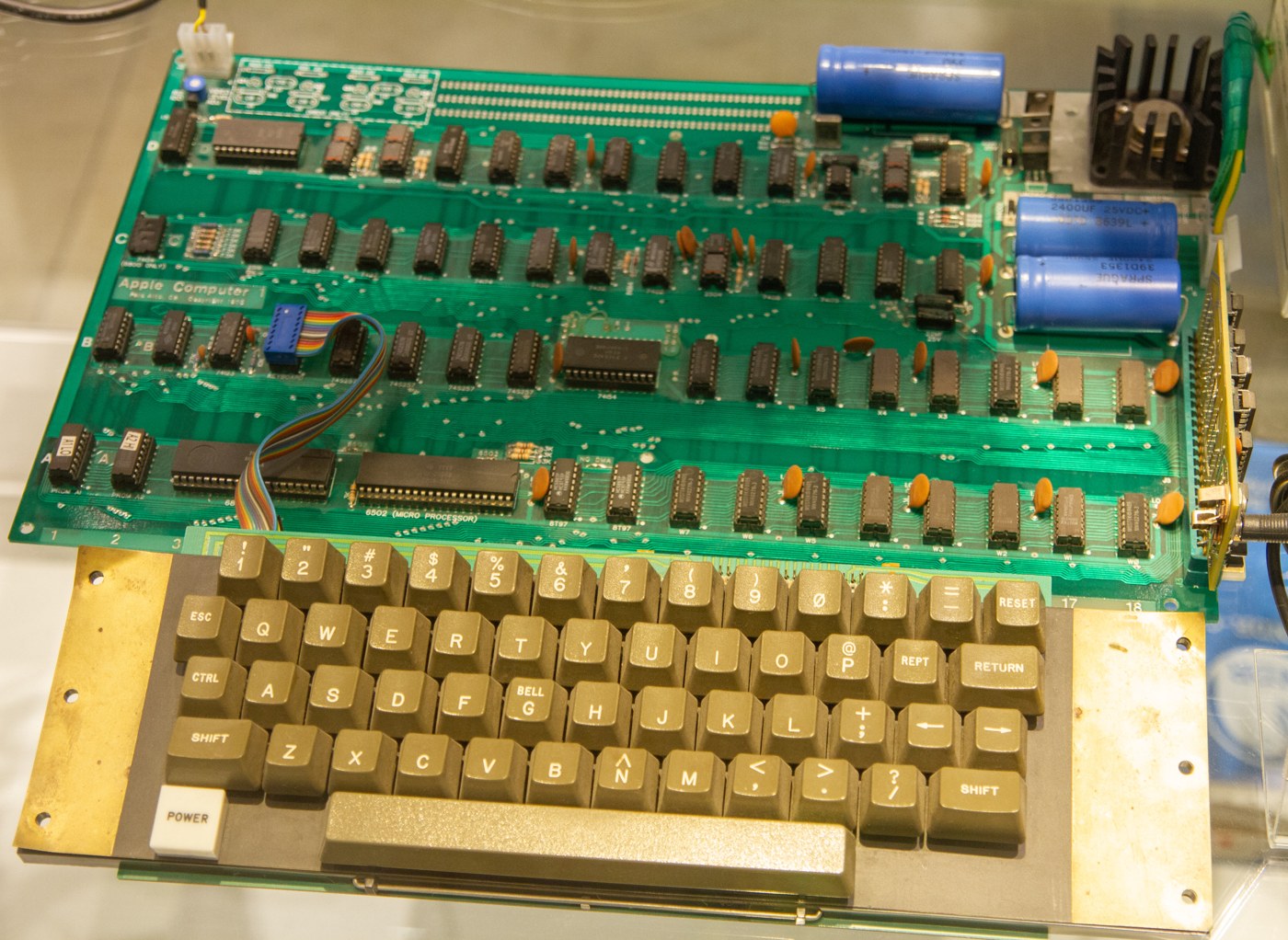 Figure 1 — An Apple-1 displayed with a period keyboard, photographed in 2019. A complete, working board with the right accessories and a documented history is the kind of Apple-1 that has sold for between $30…