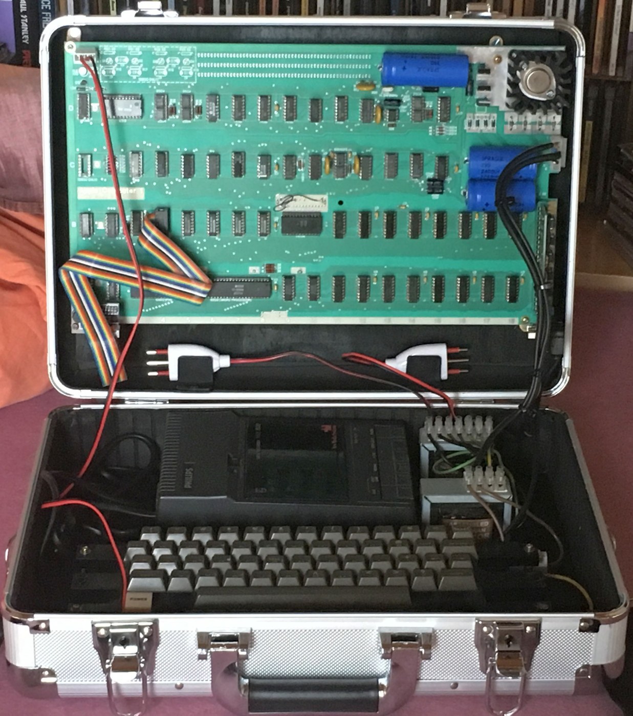 Figure 5 — A Mimeo 1 replica board, built into an aluminium briefcase with keyboard and cassette deck. The Mimeo reproduces the layout of a first-run Apple-1 closely enough that a casual observer could take i…