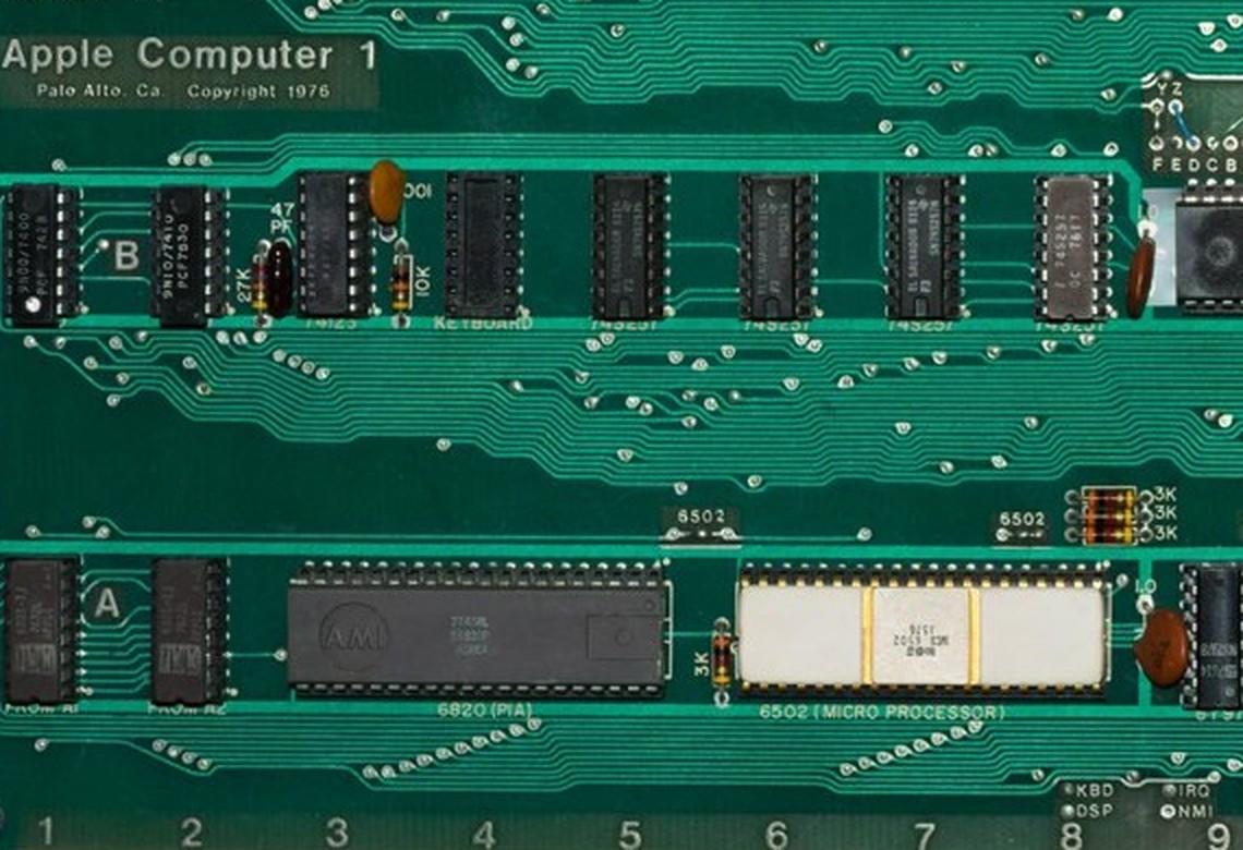 Figure 3 — Detail of the Smithsonian's first-run board: the "Apple Computer 1 / Palo Alto, Ca. Copyright 1976" silkscreen, the two Woz Monitor PROMs at positions A1 and A2, the AMI-made 6820 PIA and the white…