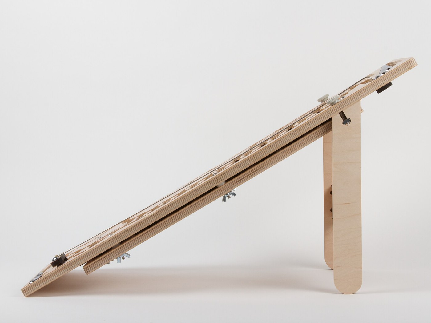 Figure 6 — For comparison, Evil Mad Scientist's plywood Digi-Comp II on its stand, which holds the board at 30 degrees (about 20 degrees with the stand reversed). A rolling-ball computer depends on a level ba…