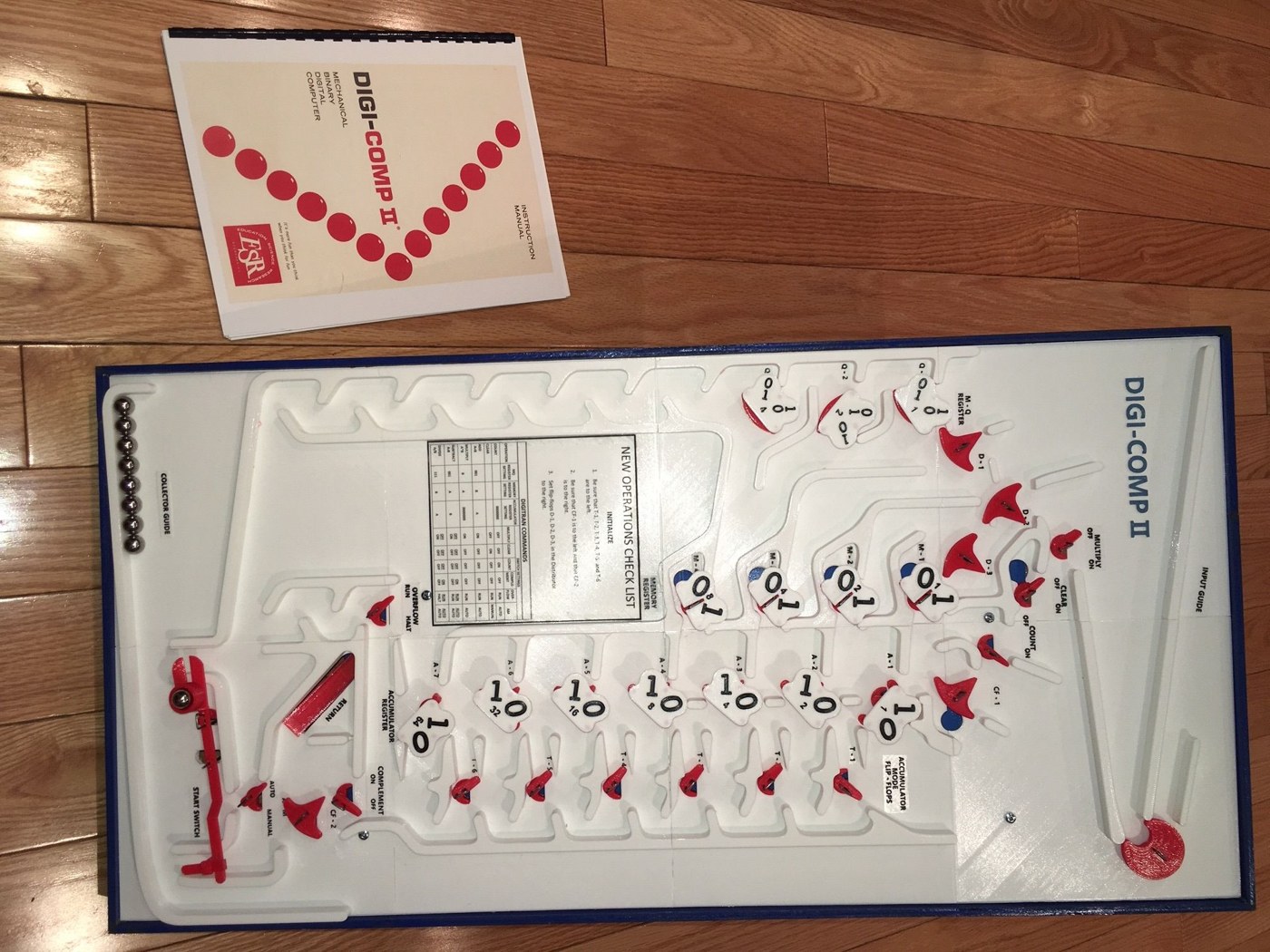 Figure 2 — Gardi's finished replica with a spiral-bound reprint of the original E.S.R. manual, printed from the PDF that accompanies the files. The labels on the deck — MULTIPLY, CLEAR, COUNT, the register na…