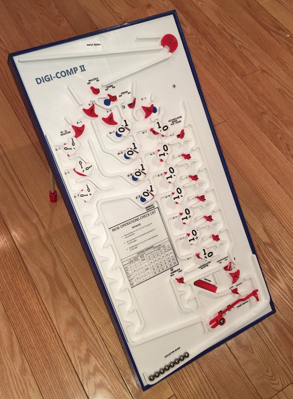 Figure 7 — Michael Gardi's full-size 3D-printed Digi-Comp II Replica (2019): white printed decks with blue guides and red and white flip-flops, the programmer's card in the middle, and the marble rack across …