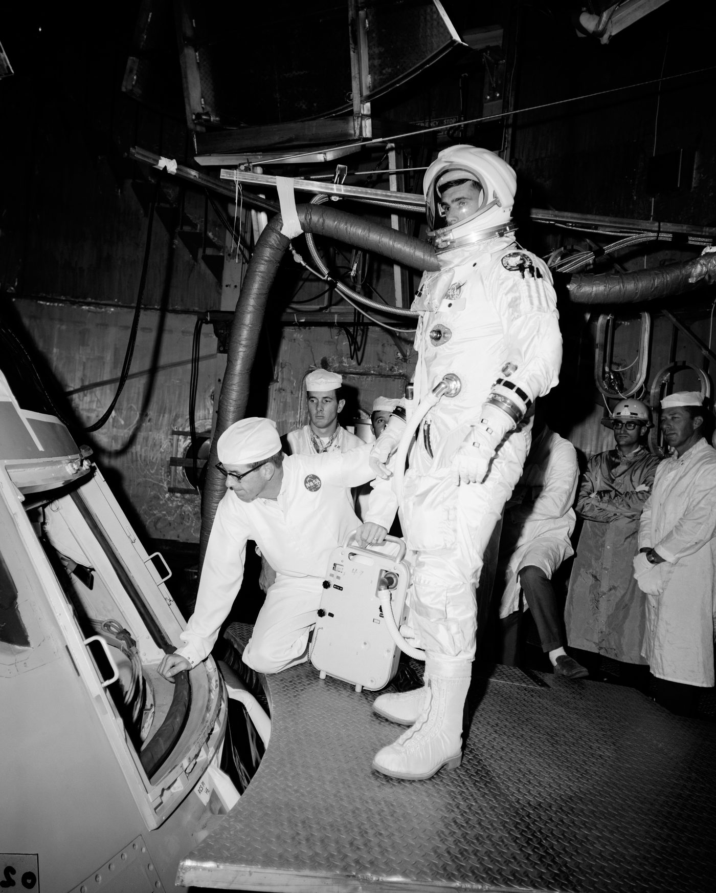 Figure 2 — The Apollo 1 prime crew — Ed White, Gus Grissom, and Roger Chaffee — with their Block I command module before the fire of 27 January 1967. Photo: File:White, Grissom and Chaffee Apollo S…