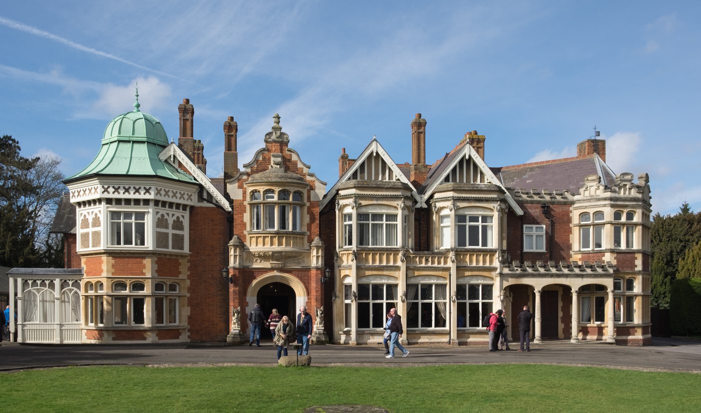 Figure 3 — The mansion at Bletchley Park, fifty miles north of London, where Britain concentrated its codebreaking effort. At its peak the surrounding huts employed nearly ten thousand people. Phot…