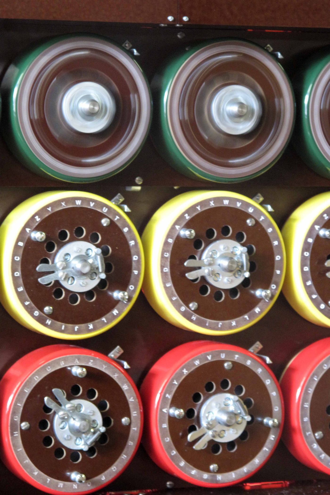 Figure 2 — Bombe drums close up: each drum's concentric rings of contacts emulate the wiring of one Enigma rotor, and three stacked drums form one scrambler. File:Rotating upper bombe drum.jpg by T…