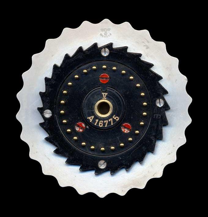 Figure 3 — The exposed face of an Enigma rotor, showing the spring-loaded pin contacts that carry current from one wheel to the next. Each rotor performs a scrambled substitution that changes as th…