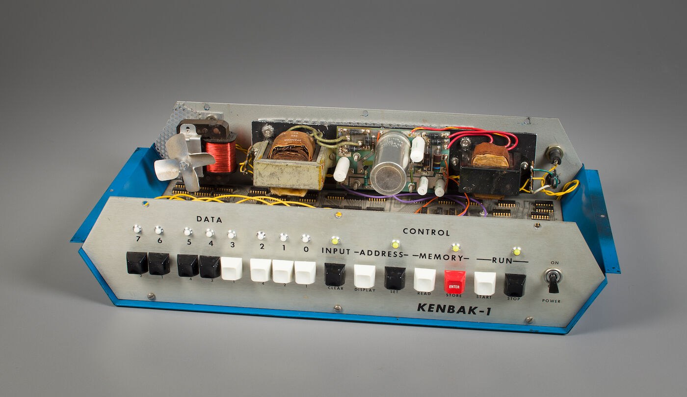 Figure 5 — The prototype with its top cover lifted, showing the power supplies and transformers above the logic board. Kenbak's machines were sent out for trial by UPS or by bus; the Installation & Maintenanc…