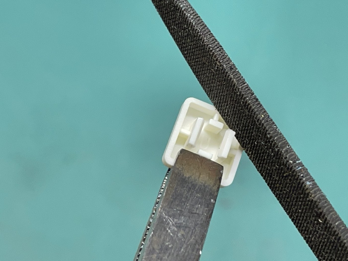 Figure 7 — The addendum's fix for a binding key: filing back the edge of the "ears" on the underside of the key cap that grip the tactile switch.