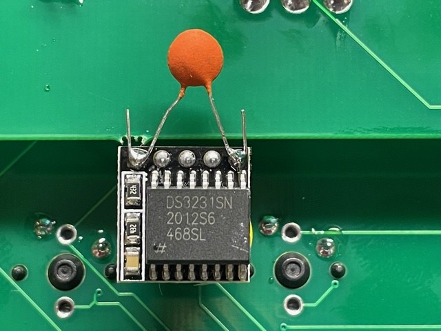Figure 8 — The clock fix: a small ceramic disc capacitor soldered across the power and ground pins of the DS3231 module.