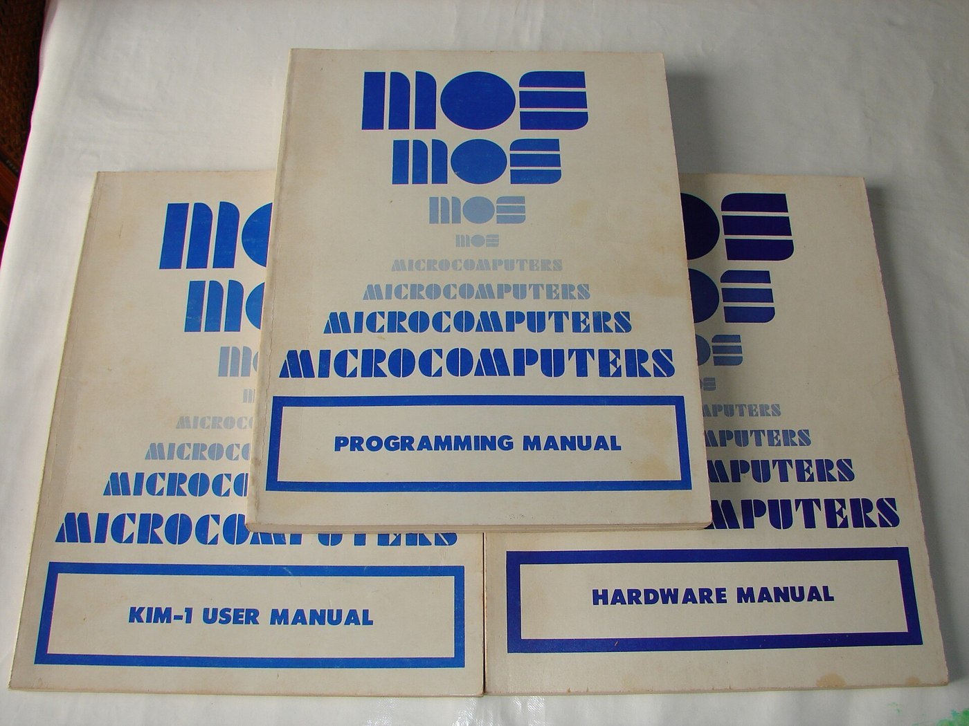 Figure 6 — The documentation that came in the box: the KIM-1 User Manual, the MCS6500 Hardware Manual and the Programming Manual, in MOS Technology's blue "MICROCOMPUTERS" covers. Peddle later said the manual…