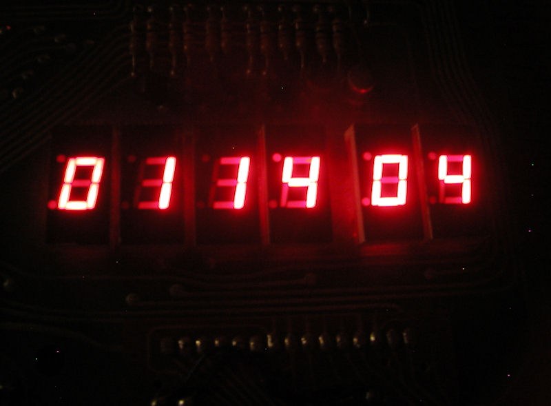 Figure 1 — The KIM-1's six LED digits lit in a dark room: four digits of address on the left, a gap, two digits of data on the right. This display, driven entirely by the monitor's software, was the whole of …