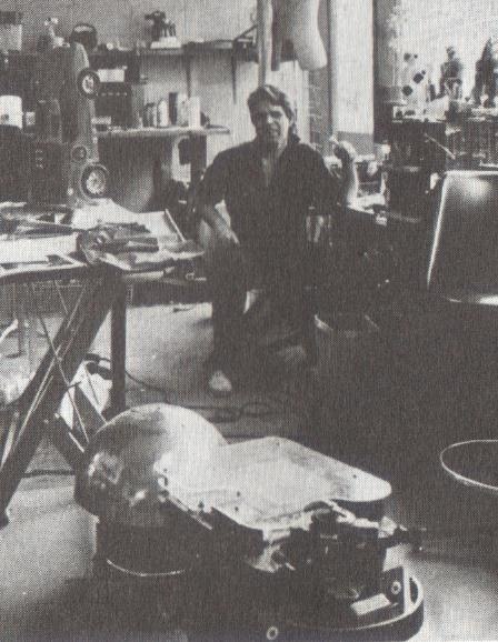 Figure 7 — Gene Oldfield with Entropy, a KIM-controlled robot begun about 1976: a three-wheeled base with a car battery, sonar and bump sensors, wired to a KIM-1 through a handful of interface chips.
