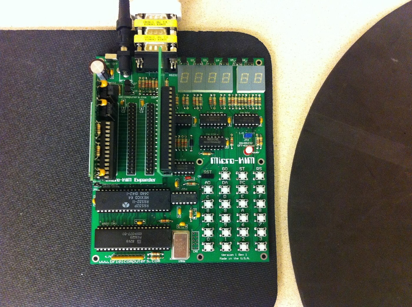 Figure 3 — Vince Briel's Micro-KIM of 2007, the first KIM-1 clone to run the unmodified monitor. A small board with tactile keys and a single 6532, here with Briel's expander board plugged in at the left and …