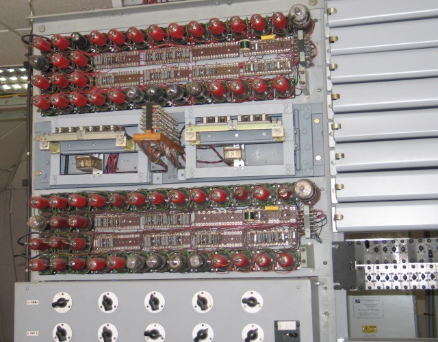 Figure 4 — Detail of the rebuilt Colossus at Bletchley Park in 2009: rows of valves in red-capped holders above a bank of rotary switches. The team's ingenuity went into the parts no photograph showed — the t…