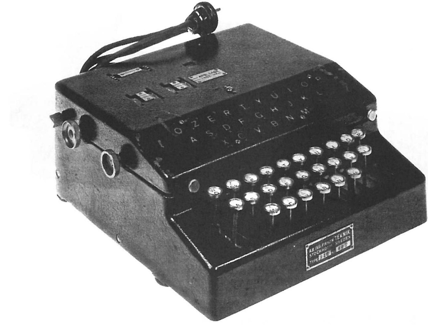 Figure 6 — The production B-21, with its Enigma-like keyboard and lamp board, a mains lead for the solenoid that stepped the rotors, and the maker's plate of AB Ingeniörsfirman Teknik. Hagelin's own photograp…