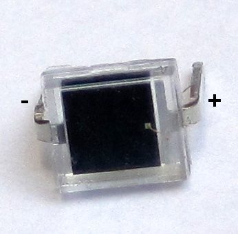 Figure 7 — The BPW34 silicon PIN photodiode: a 7.5 mm² chip in a clear package, here with its anode (−) and cathode (+) marked. In the reproduction it replaces Lehmer's photo-electric cell.