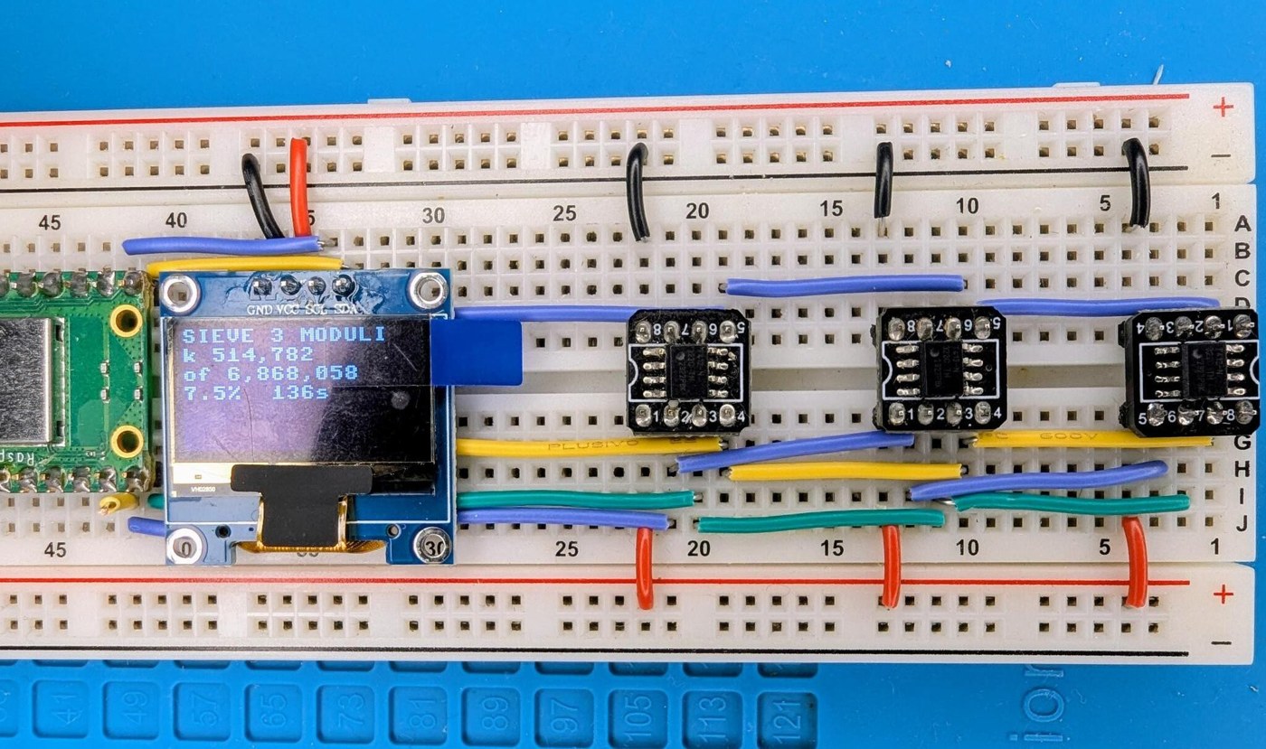 Figure 4 — Build 02: three ATtiny412s and a Pico on a breadboard factoring 5,283,065,753,709,209. With only three moduli, one candidate in eight survives and the Pico's checking dominates the run.