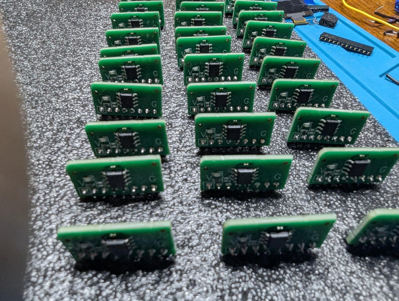Figure 13 — Thirty assembled modulus cards, one per modulus, ready for the backplane. Every card is identical; the modulus is loaded over I²C at the start of each run.