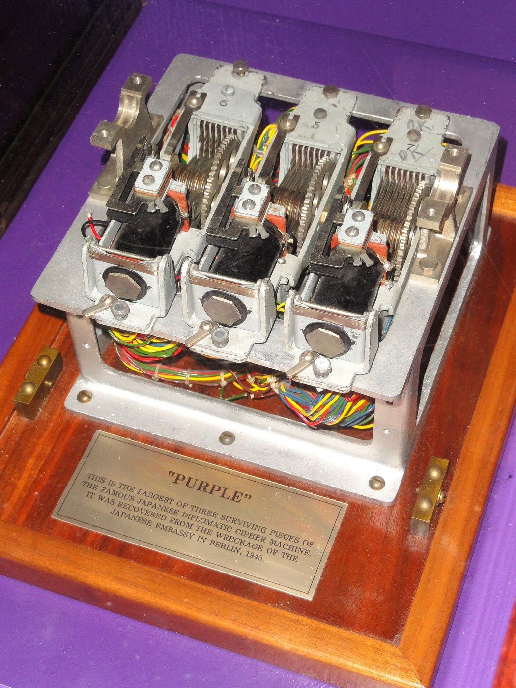 Figure 1 — The largest surviving piece of a real PURPLE machine: three seven-level stepping switches on an aluminium frame, with their colour-coded wiring harness underneath, recovered from the wreckage of th…