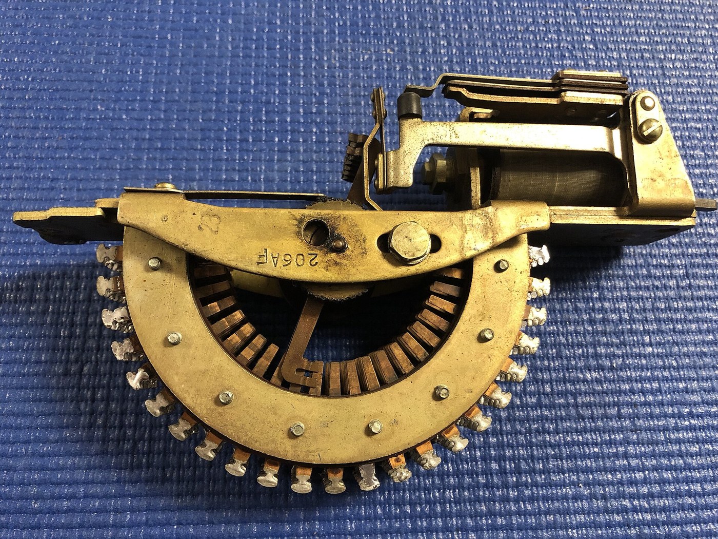 Figure 2 — A Western Electric 206A stepping switch at the Telephone Museum, Waltham: six levels of 25 contacts on a half-ring bank, with the stepping magnet behind. A switch of exactly this kind — six levels,…