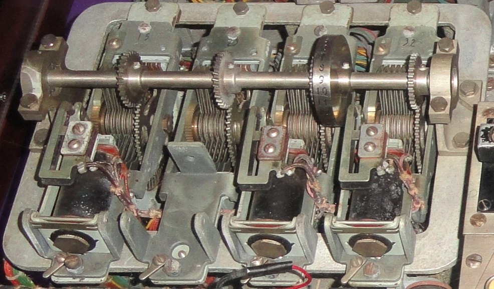 Figure 6 — One permutation stage of the captured JADE: four seven-level stepping switches driven together on a common shaft, with their stepping magnets below. The mechanical design matches the PURPLE fragmen…